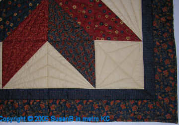 detail of Rust/Navy Big Star Quilt showing quilting